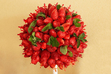 Red strawberry with mint on a yellow background. Delicious, juicy, sweet, fresh berry. 