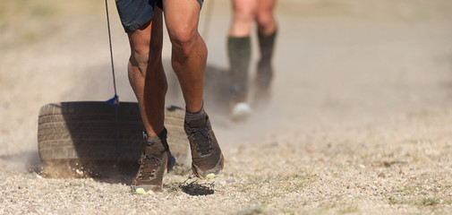 Athlete pulling car tires at a training run © pavel1964