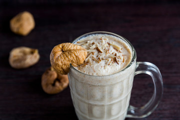 Anjeer milk shake or dried fig milk shake with almonds - selective focus