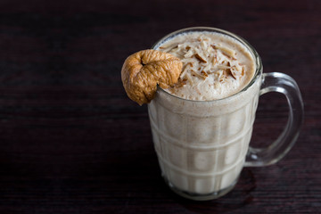Anjeer milk shake or dried fig milk shake with almonds - selective focus