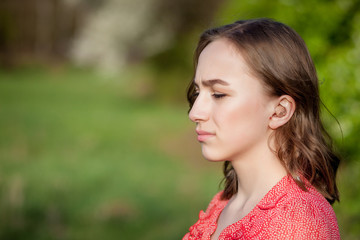 Close-up Of Female Hands Putting Hearing Aid In Ear. Modern digital in the ear hearing aid for deafness and the hard of hearing patients