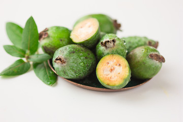 Green feijoa fruits isolated on white background. Fruits of feijoa on a white background. Tropical fruit feijoa isolated on white background. Set of ripe feijoa fruits.