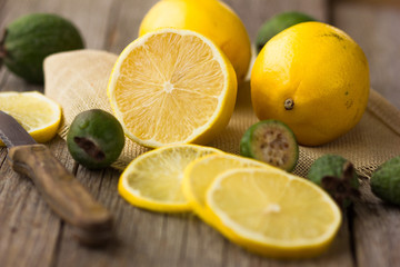 Half of lemon on a wooden board. Lemons on a wooden background. Lemons. Fruits. Lemon halves. Mint. Healthy food concept