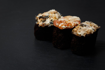 Juicy Gunkan Maki Sushi on black slate