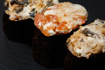 Juicy Gunkan Maki Sushi on black slate