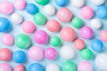 Colorful balloons pattern on blue table top view. Birthday or party background. Flat lay style.