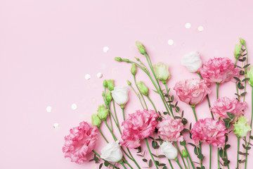 Mother day greeting card. Beautiful spring flowers on pastel pink table top view. Flat lay.