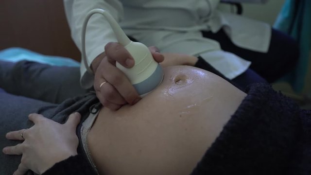 Pregnant woman at clinic.Doctor made examination of baby at ultrasound scan. 4K.