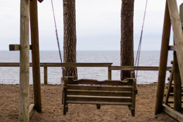 Wooden swing on a beach during early spring