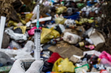 Find a syringe for drug use found in a landfill. Incorrect disposal of medical waste