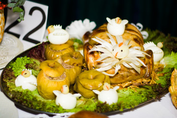 stuffed baked duck with apples on a tray in a restaurant
