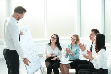 group of businesspeople clapping hands during meeting presentation