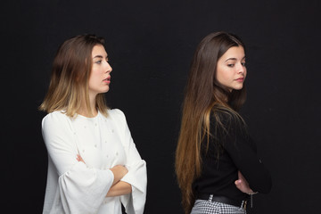 Two angry girls on a black background