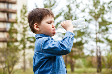 child drinking water from a bottle