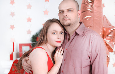 portrait of happy loving couple on Christmas living room background