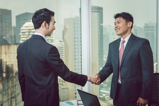 Businessman shaking hand with his partner