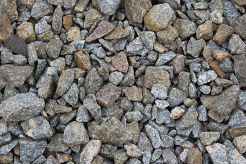 Multi-colored stones on the ground. Different shapes and sizes