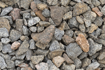 Multi-colored stones on the ground. Different shapes and sizes
