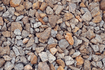 Multi-colored stones on the ground. Different shapes and sizes