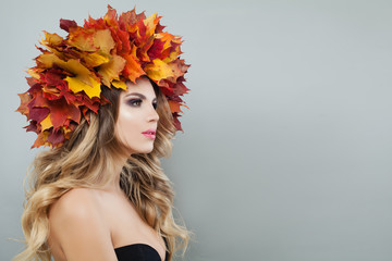 Autumn portrait of beautiful model woman in colorful autumn leaves crown