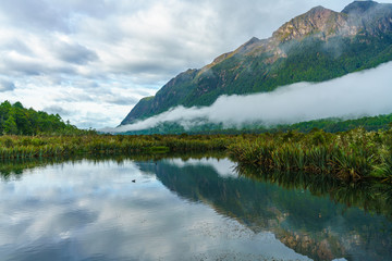reflections of mountains in the mirror lakes, new zealand 7