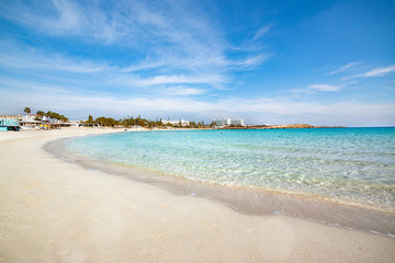 Fototapeta na wymiar Famous Nissi beach, Ayia Napa. Famagusta District, Cyprus. Traces on sand and blue lagoon.