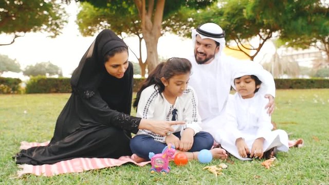 Happy family spending time together at the park in Dubai