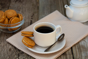 Cup of coffee with sweet cookies, ginger bread. Abstract breakfast image. Rustick wooden background.