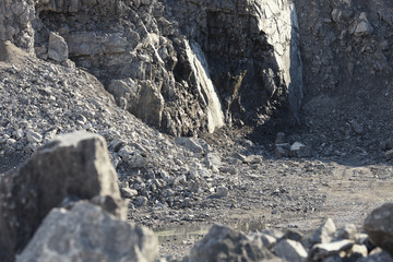 Rocks and placer ore inside lime stone quarry.