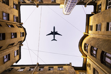 House well. The aircraft, the plane flies over the house. Old town house. Bottom view.
