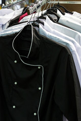 Several single-breasted cook on hanger close up 