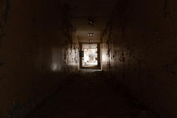 Abandoned hallway with light at the end