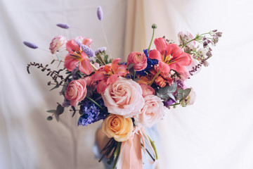 Young woman in a light blue dress holding a bouquet of flowers. Romantic concept.
