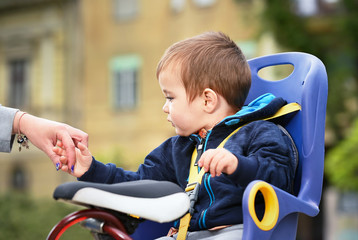 child boy sitting on bicycle chair
