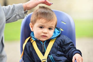 child boy sitting on bicycle chair