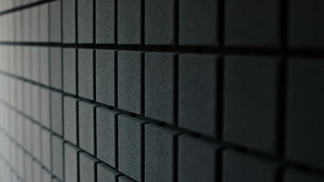Close-up of beautiful black acoustic foam for sound recording studio. Soundproof wall in stylish sound studio.