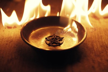 Old pentagram burning in flames