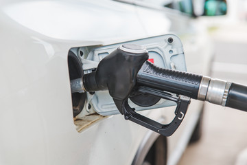 filling up car tank at gas station.