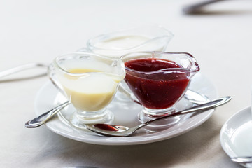 Various sweet sauces on a white plate, selective focus