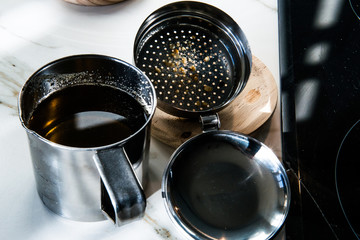 Metal container in a kitchen with used cooking oil