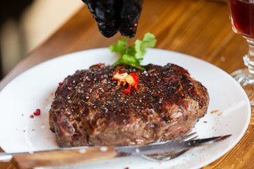Beef steak cooking. Rib eye steak. Raw meat. Juicy marbled meat on BBQ grill. Medium rare meat roasting