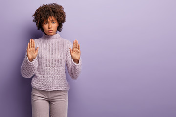 No, I refuse. Beautiful angry dark skinned woman shows palms, makes stop gesture with both hands,...