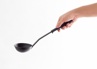 woman hand holding black ladle dipper isolated