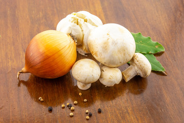 It's time to cook! Fresh mushrooms with spices on a wooden base