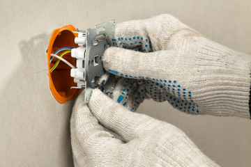 installing an electrical outlet in the socket box on the plasterboard wall