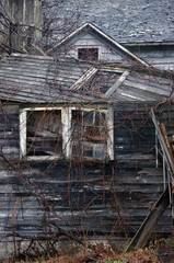 Fototapeta na wymiar abandoned barn walls and windows collapsing