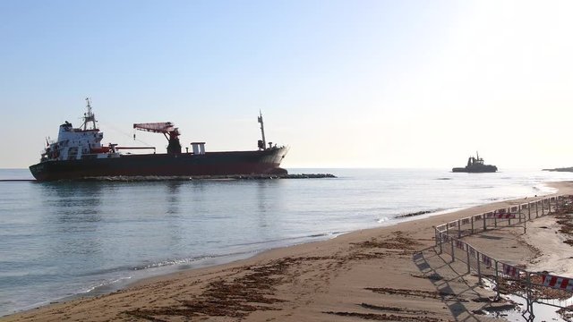 a merchant stuck on a sandy beach on a sunny day