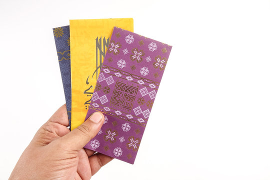 Money packet during Eid Fitr on white. Arabic characters means Happy Eid Mubarak.