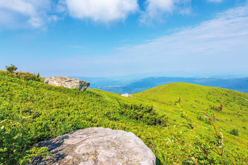 Naklejka premium mountain landscape on summer morning. meadows on the hills decorated with big white sharp rocks. beautiful green and blue nature scenery on a sunny day. explore back-country