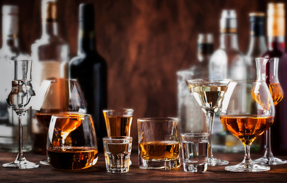Strong Spirits Set. Hard alcoholic drinks in glasses in assortment: vodka, cognac, tequila, brandy and whiskey, grappa, liqueur, vermouth, tincture, rum. 